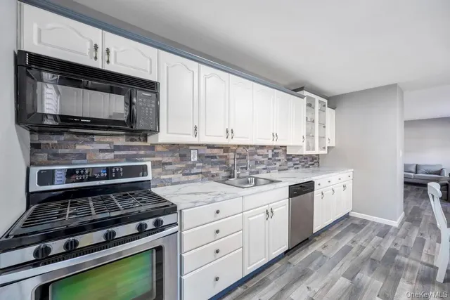 a kitchen with stainless steel appliances a stove microwave and cabinets
