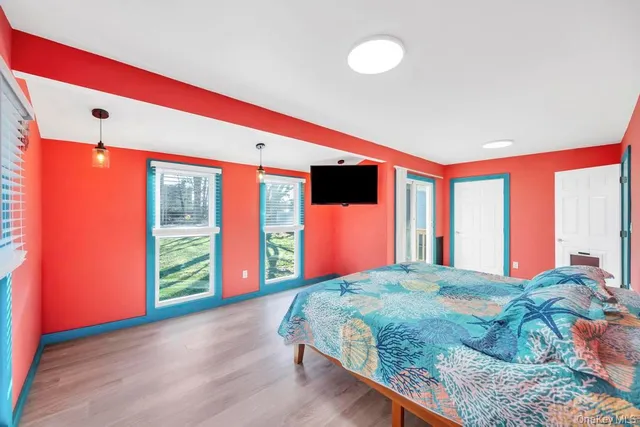 a bedroom with a bed and a flat screen tv