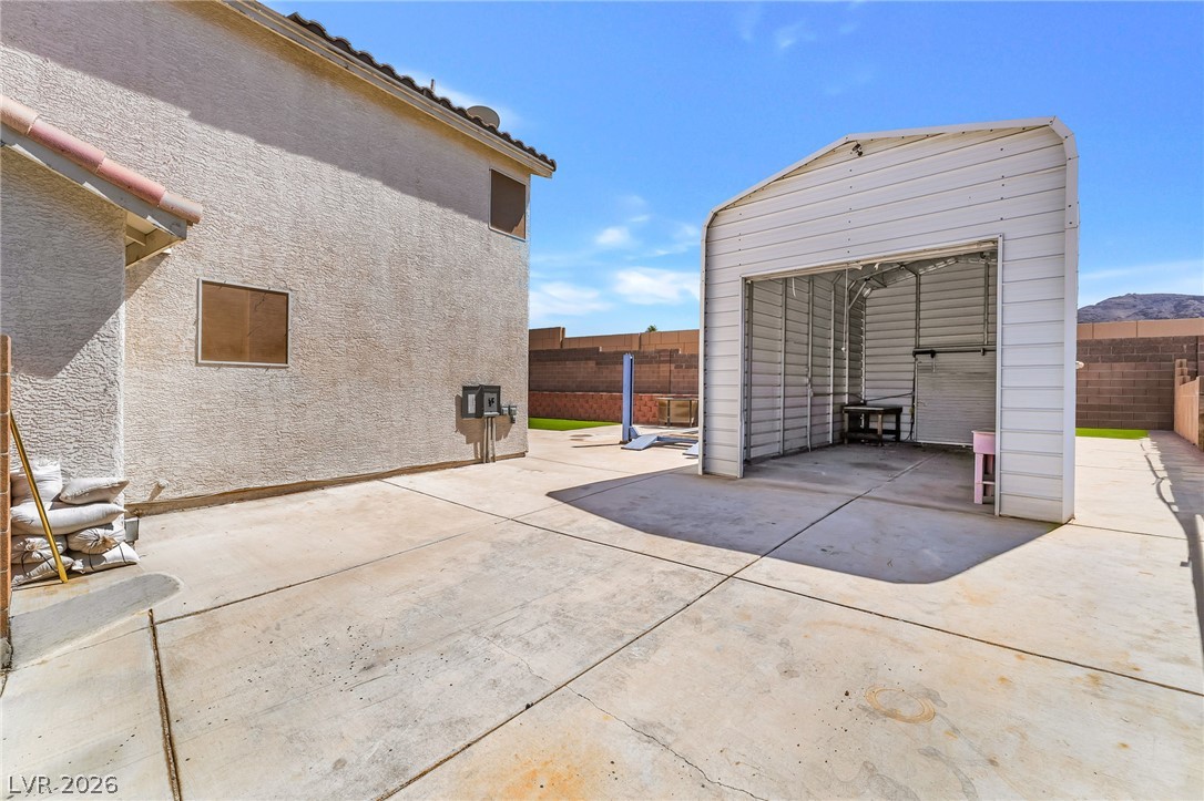 104 Appian Way Henderson, NV 89002 - Photo 23 of 24 A spacious backyard with a functional detached storage structure.