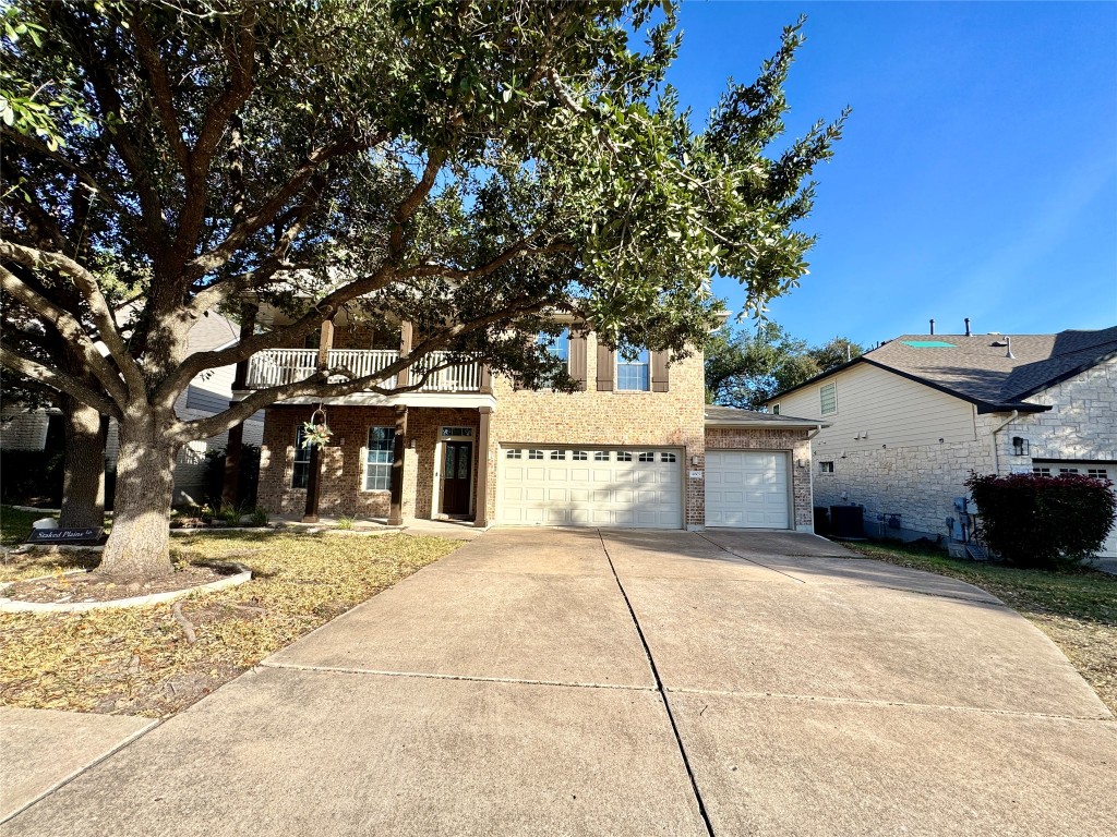 14605 Staked Plains Loop Austin, TX 78717 - Photo 1 of 30 View of front facade with brick siding, concrete driveway, a garage, and covered porch