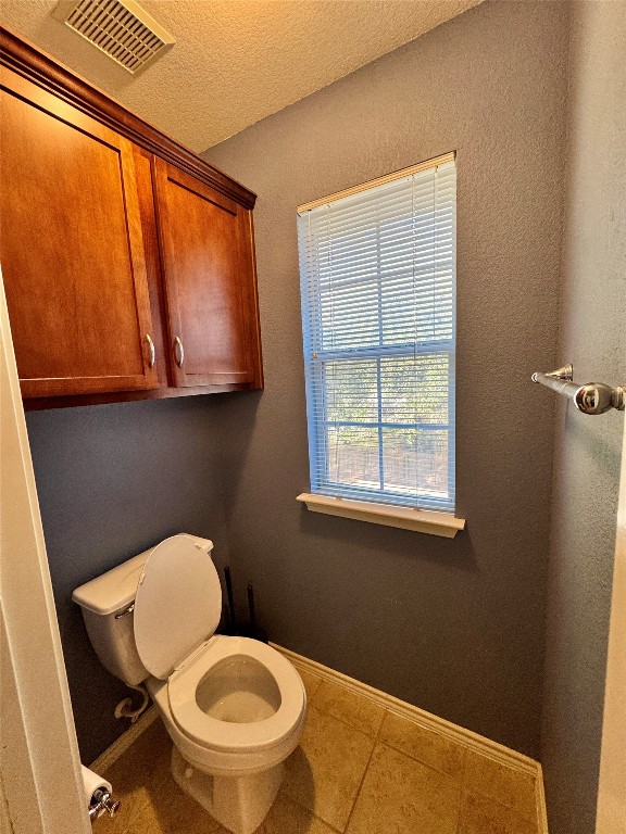 14605 Staked Plains Loop Austin, TX 78717 - Photo 13 of 30 Bathroom with tile patterned floors, a textured ceiling, and a textured wall
