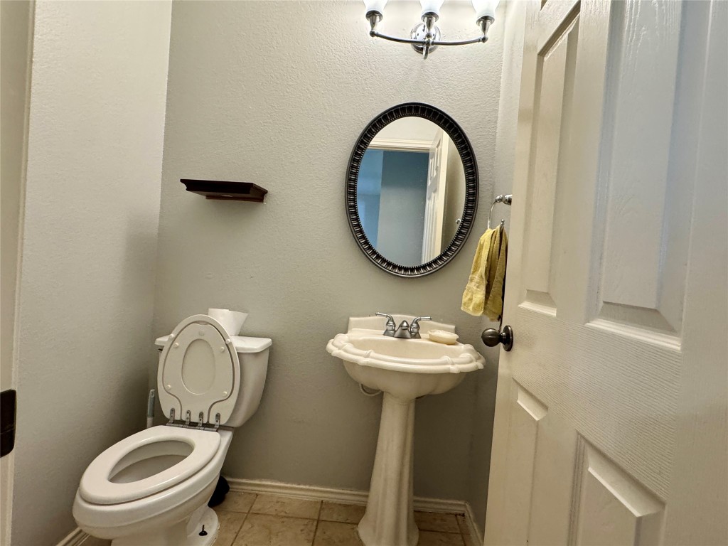 14605 Staked Plains Loop Austin, TX 78717 - Photo 21 of 30 Half bath featuring baseboards and light tile patterned floors