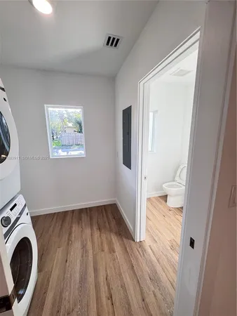 a view of washer and dryer with wooden floor