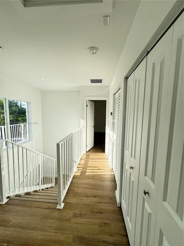 a view of wooden floor and a window