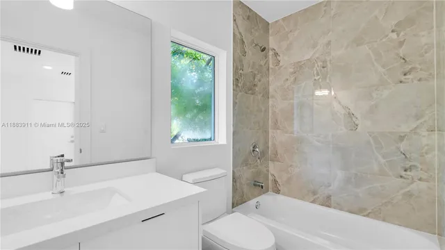 a white toilet sitting next to a shower
