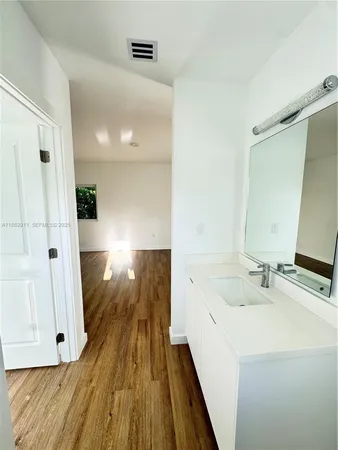 a bathroom with a sink and a large mirror