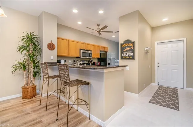 a kitchen with stainless steel appliances kitchen island granite countertop a stove a sink and a microwave
