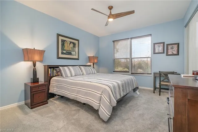 a spacious bedroom with a bed and a table