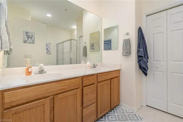 a bathroom with a sink vanity and mirror
