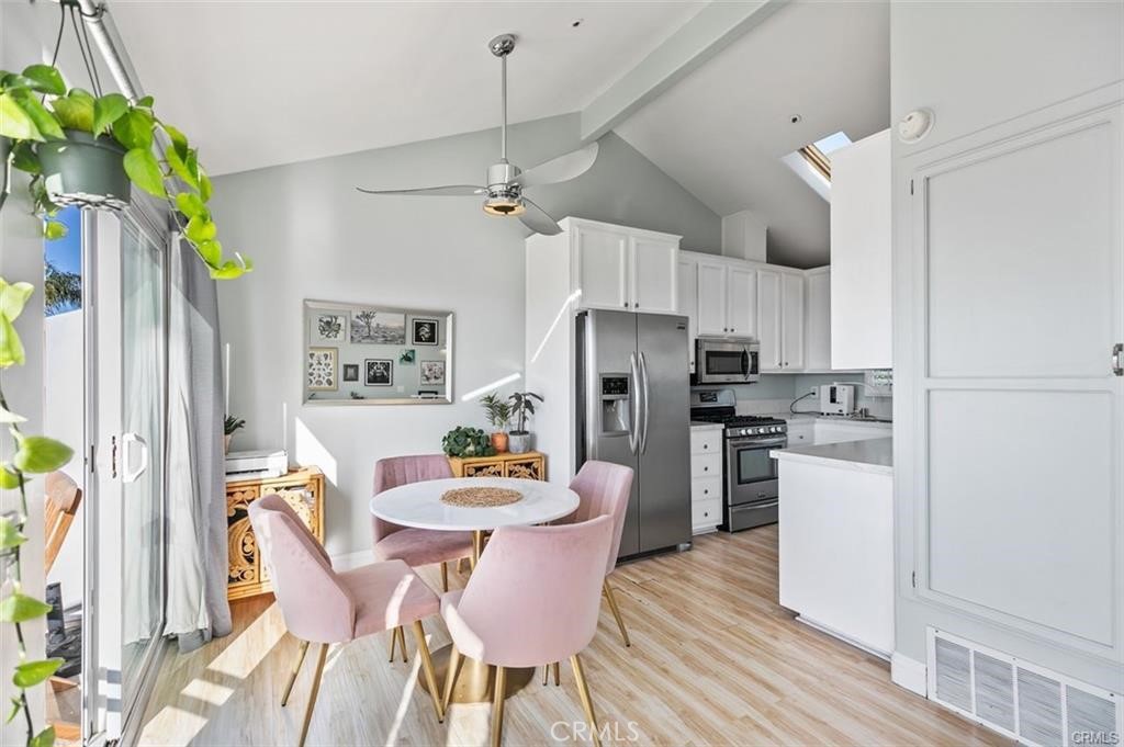 33772 Copper Lantern Street, Unit C Dana Point, CA 92629 - Photo 19 of 45 a kitchen with stainless steel appliances a dining table chairs refrigerator and microwave
