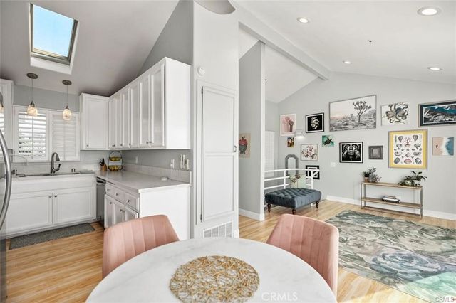 a kitchen with stainless steel appliances kitchen island granite countertop a refrigerator a stove a sink dishwasher with a dining table and chairs