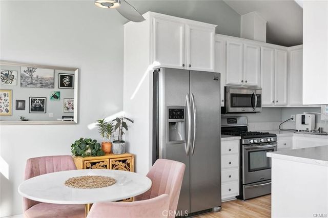 a kitchen with a sink a stove a refrigerator and cabinets