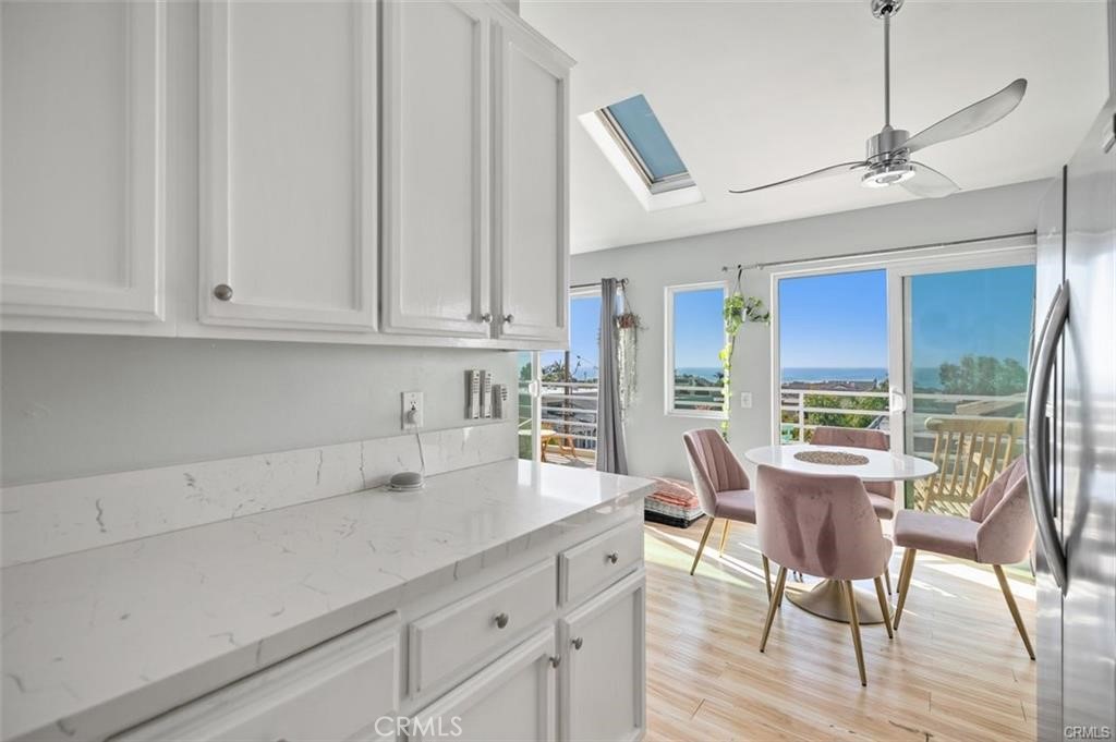 33772 Copper Lantern Street, Unit C Dana Point, CA 92629 - Photo 26 of 45 a view of a dining room with furniture window and wooden floor