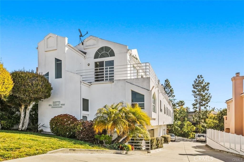 33772 Copper Lantern Street, Unit C Dana Point, CA 92629 - Photo 3 of 45 a front view of a house with a yard