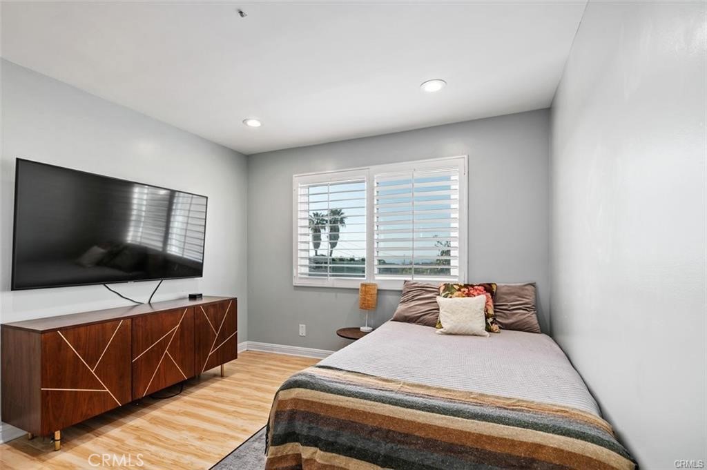 33772 Copper Lantern Street, Unit C Dana Point, CA 92629 - Photo 36 of 45 a bedroom with a bed and a flat screen tv