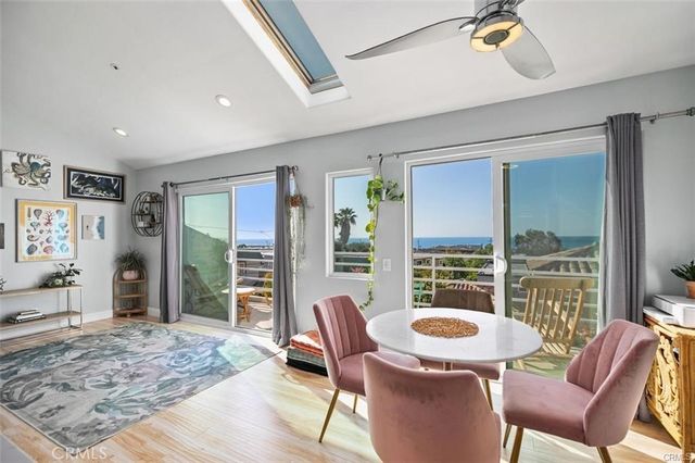 a living room with furniture a rug and a flat screen tv