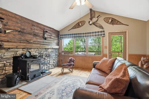 a living room with furniture a window and a fireplace