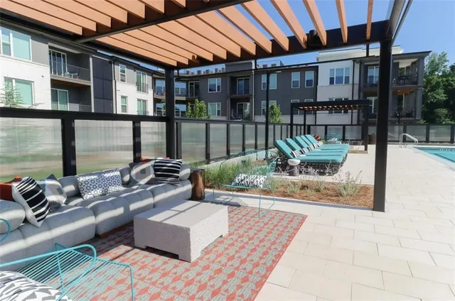 a view of a patio with couches table and chairs and potted plants