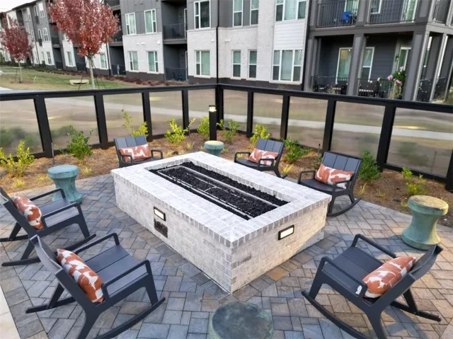 a view of a patio with a table and chairs