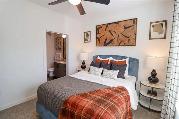 a bedroom with a bed and a painting on the wall