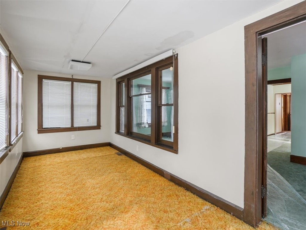 5800 Granger Road Ashtabula, OH 44004 - Photo 5 of 32 Unfurnished sunroom with a wall mounted air conditioner
