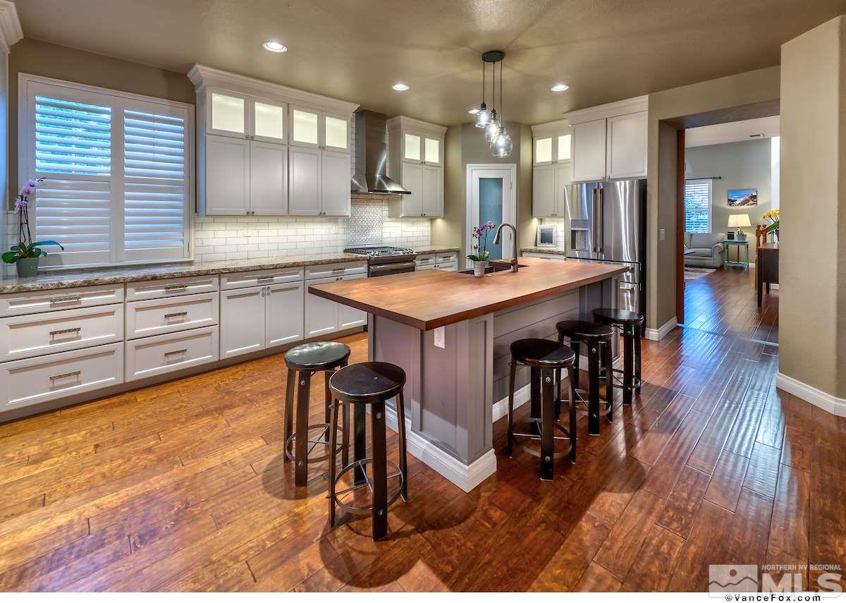 598 Needles Court Reno, NV 89521 - Photo 9 of 25 a large kitchen with a table and chairs