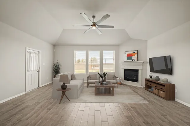 a kitchen with kitchen island granite countertop a sink appliances cabinets and wooden floor