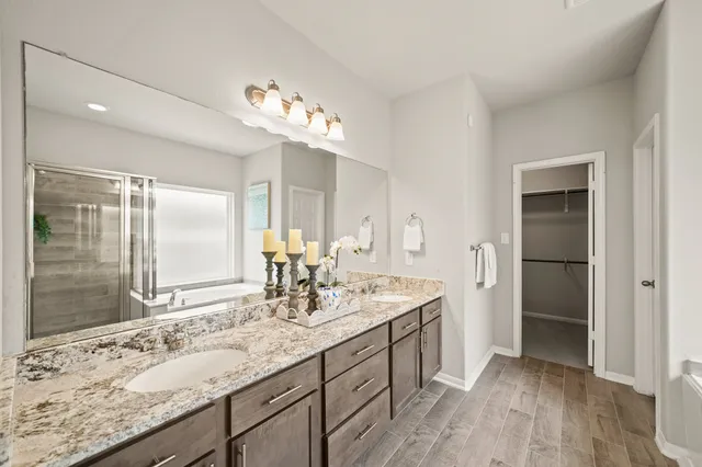 a spacious bathroom with a double vanity sink and a mirror
