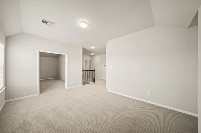 an empty room with a painting on the wall