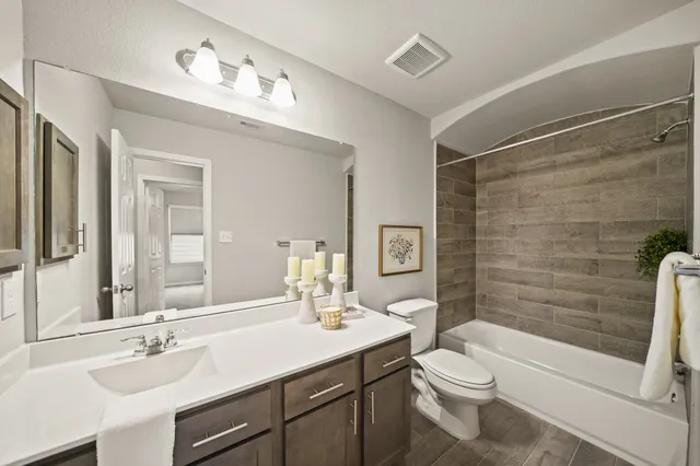 an empty room with a fan & a window