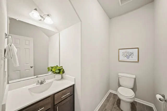 a bathroom with a sink toilet and a mirror