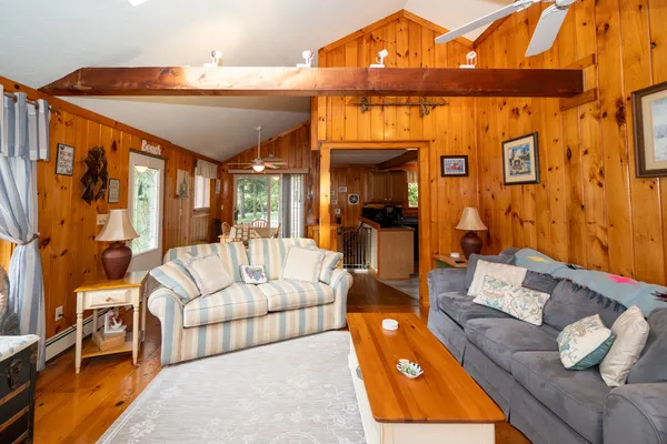 a living room with furniture and a dining table