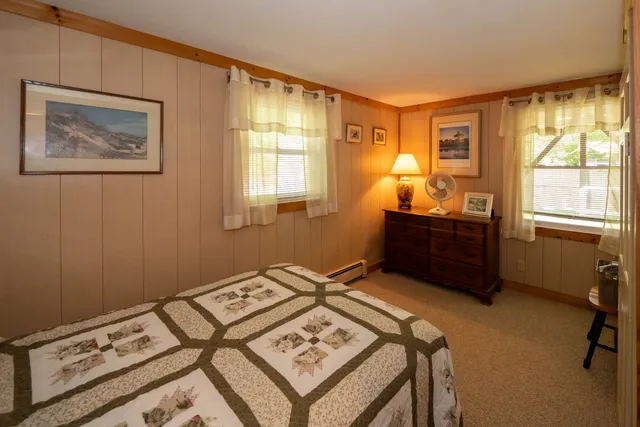 a bed sitting in a room next to a window