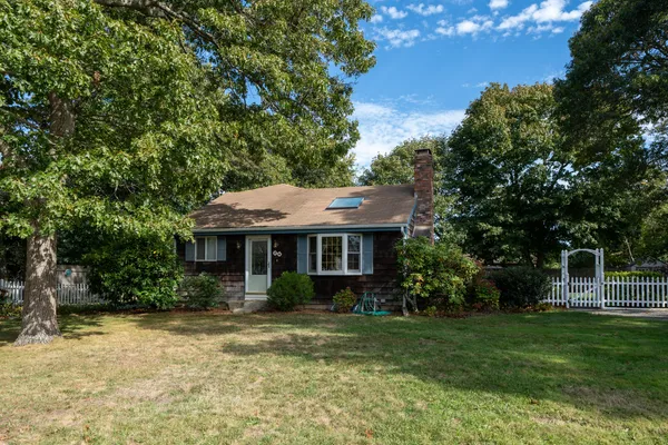 a view of an house with backyard space and garden