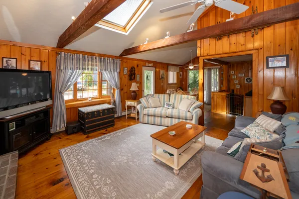 a living room with furniture fireplace and flat screen tv