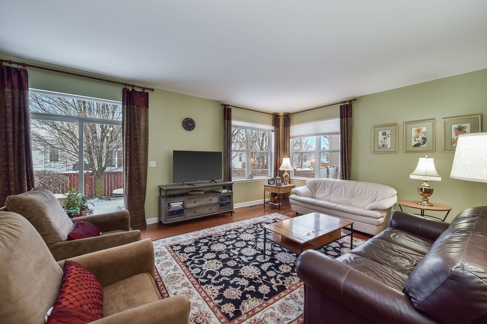 708 Bohannon Circle Oswego, IL 60543 - Photo 3 of 24 a living room with furniture a flat screen tv and a window