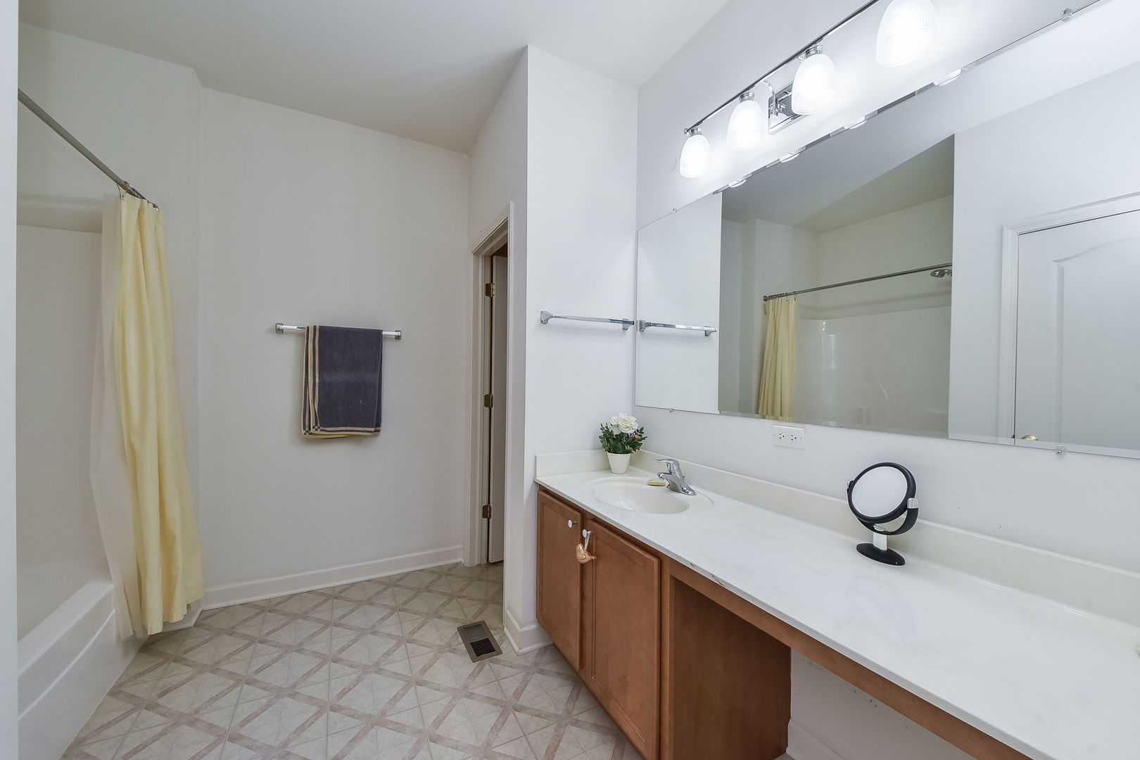 708 Bohannon Circle Oswego, IL 60543 - Photo 10 of 24 a spacious bathroom with a granite countertop sink and a mirror