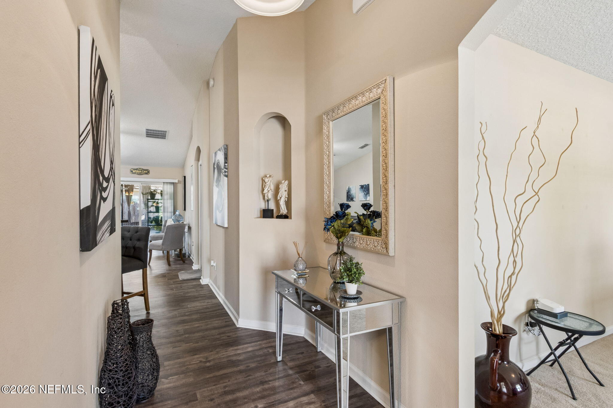 96034 Bass Lane Yulee, FL 32097 - Photo 12 of 50 a view of a hallway with wooden floor and a potted plant