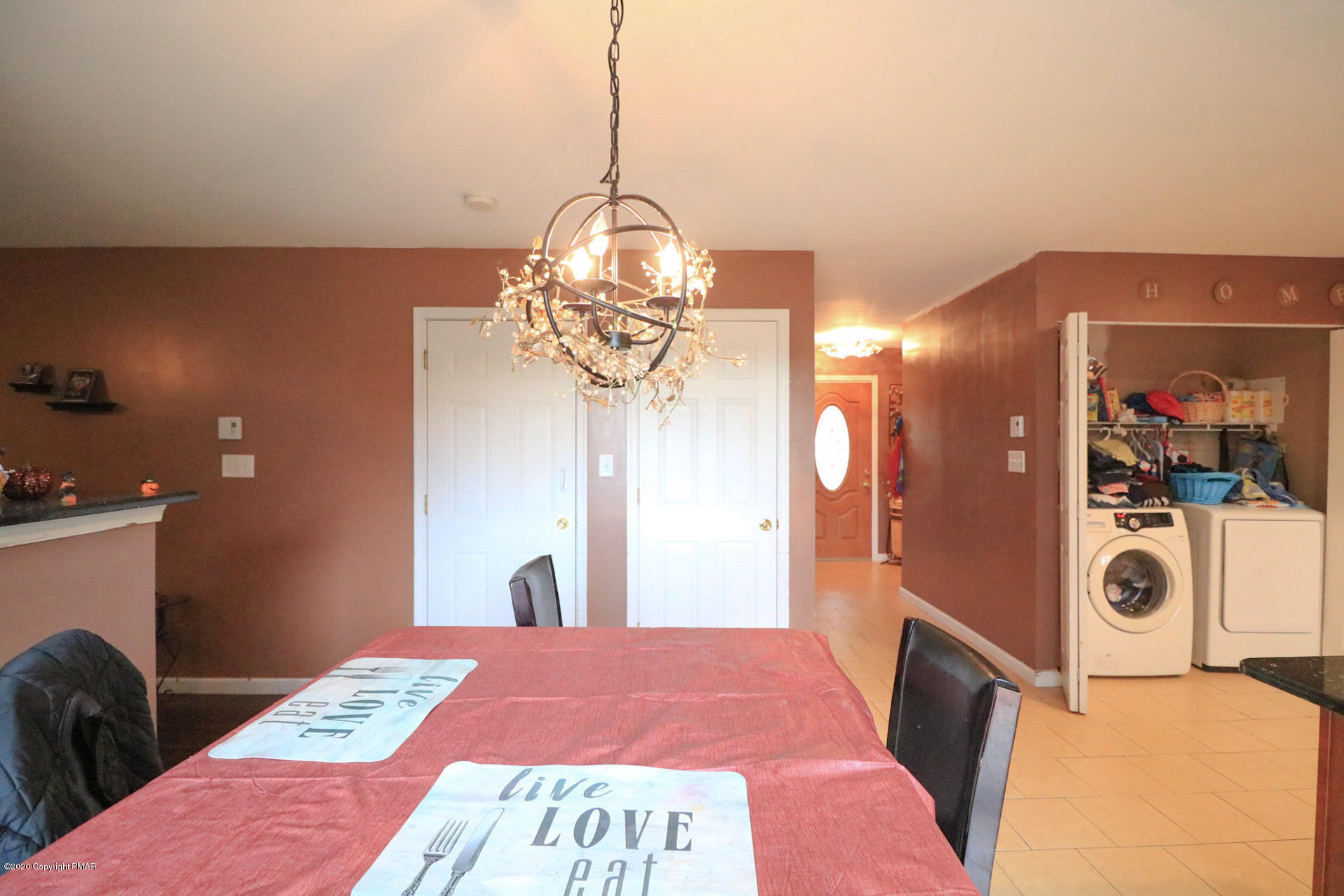 1024 State Road Effort, PA 18330 - Photo 20 of 46 a bedroom with a bed and a chandelier