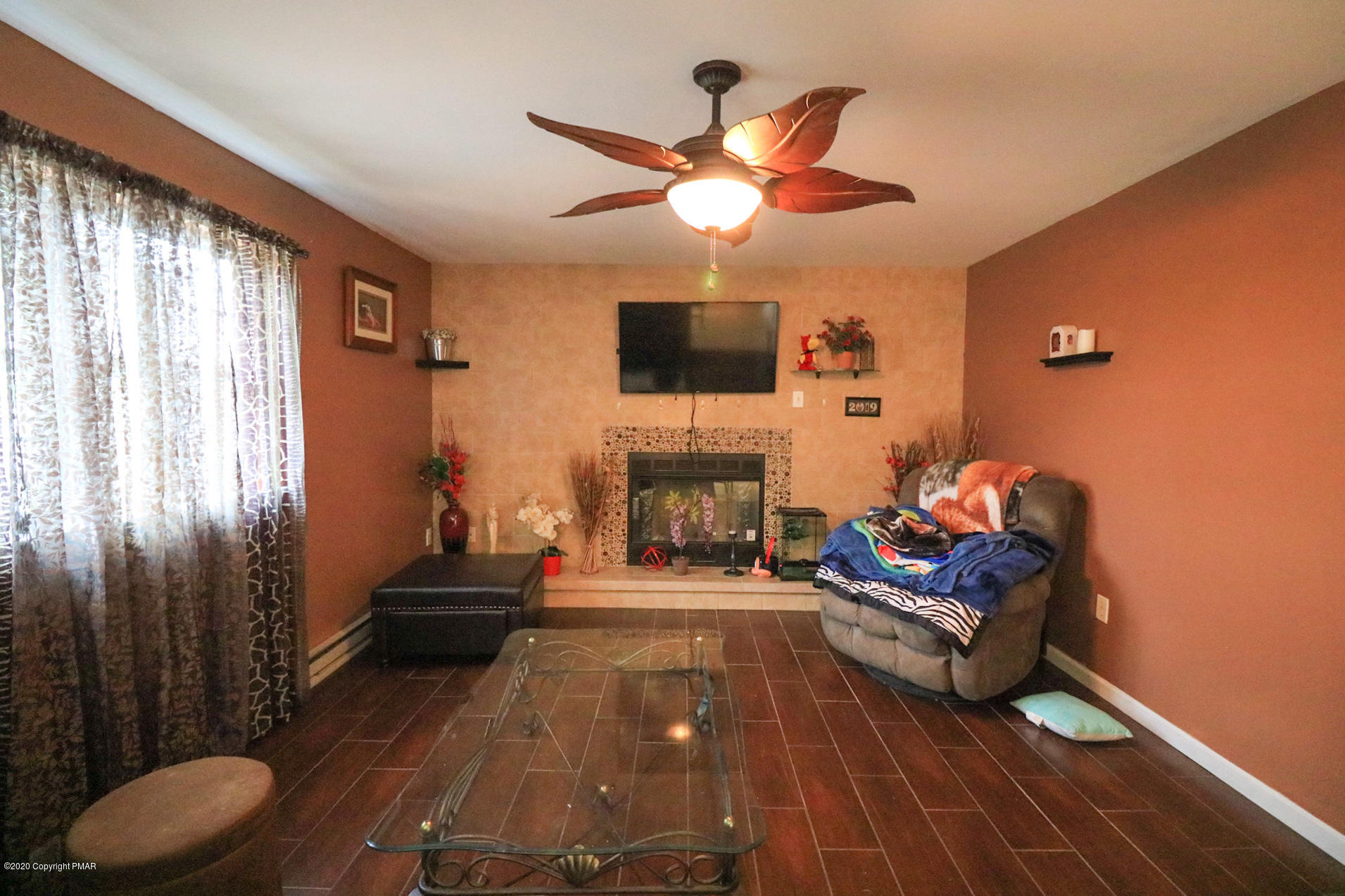 1024 State Road Effort, PA 18330 - Photo 24 of 46 a living room with furniture a flat screen tv and a fireplace