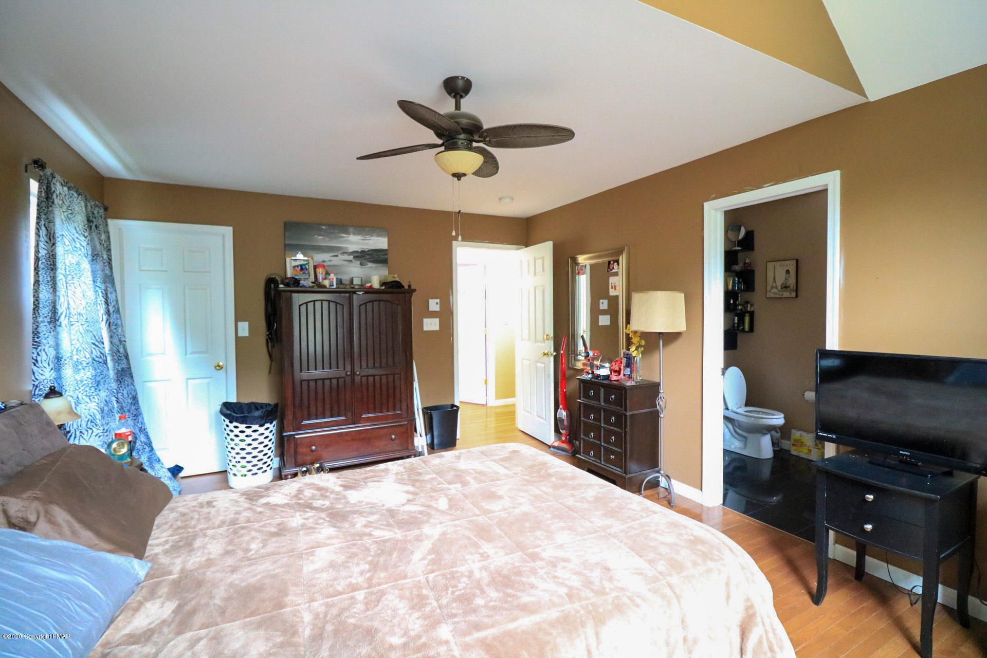1024 State Road Effort, PA 18330 - Photo 38 of 46 a bedroom with a bed and a chandelier
