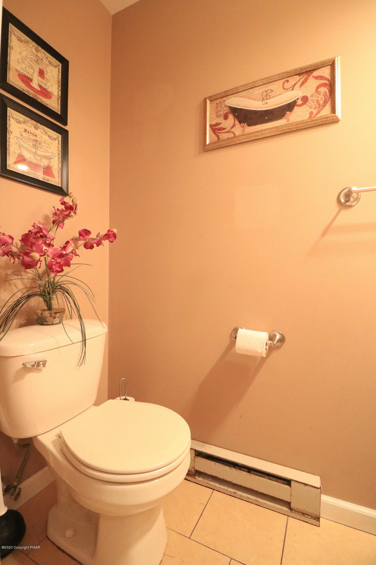 1024 State Road Effort, PA 18330 - Photo 8 of 46 a white toilet sitting next to a bathroom sink and a mirror