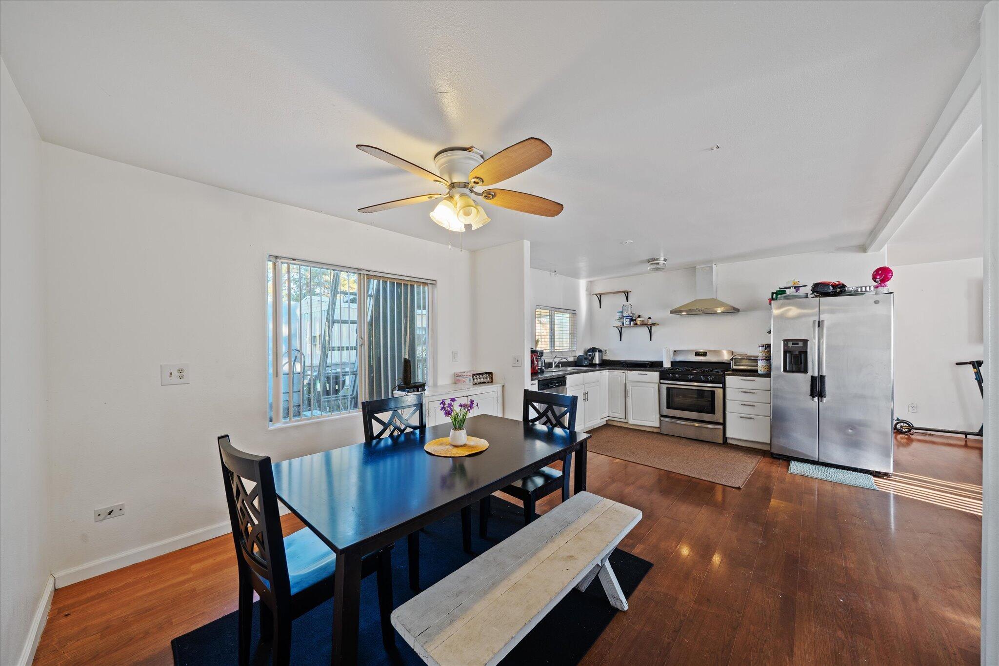 2494 Delta Place, Unit 71 Redding, CA 96002 - Photo 12 of 24 a view of a dining room with furniture and wooden floor