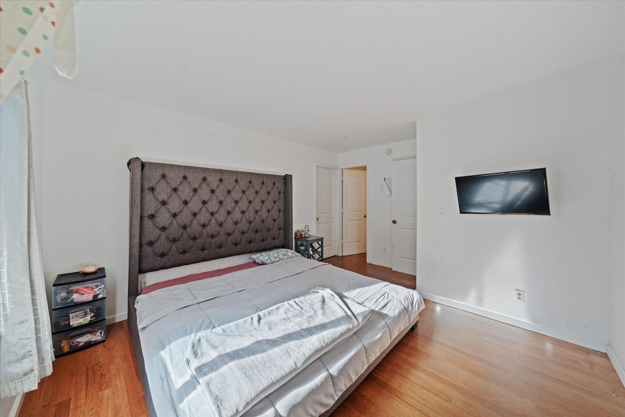 2494 Delta Place, Unit 71 Redding, CA 96002 - Photo 16 of 24 a bedroom with a bed and a flat tv screen on the dresser