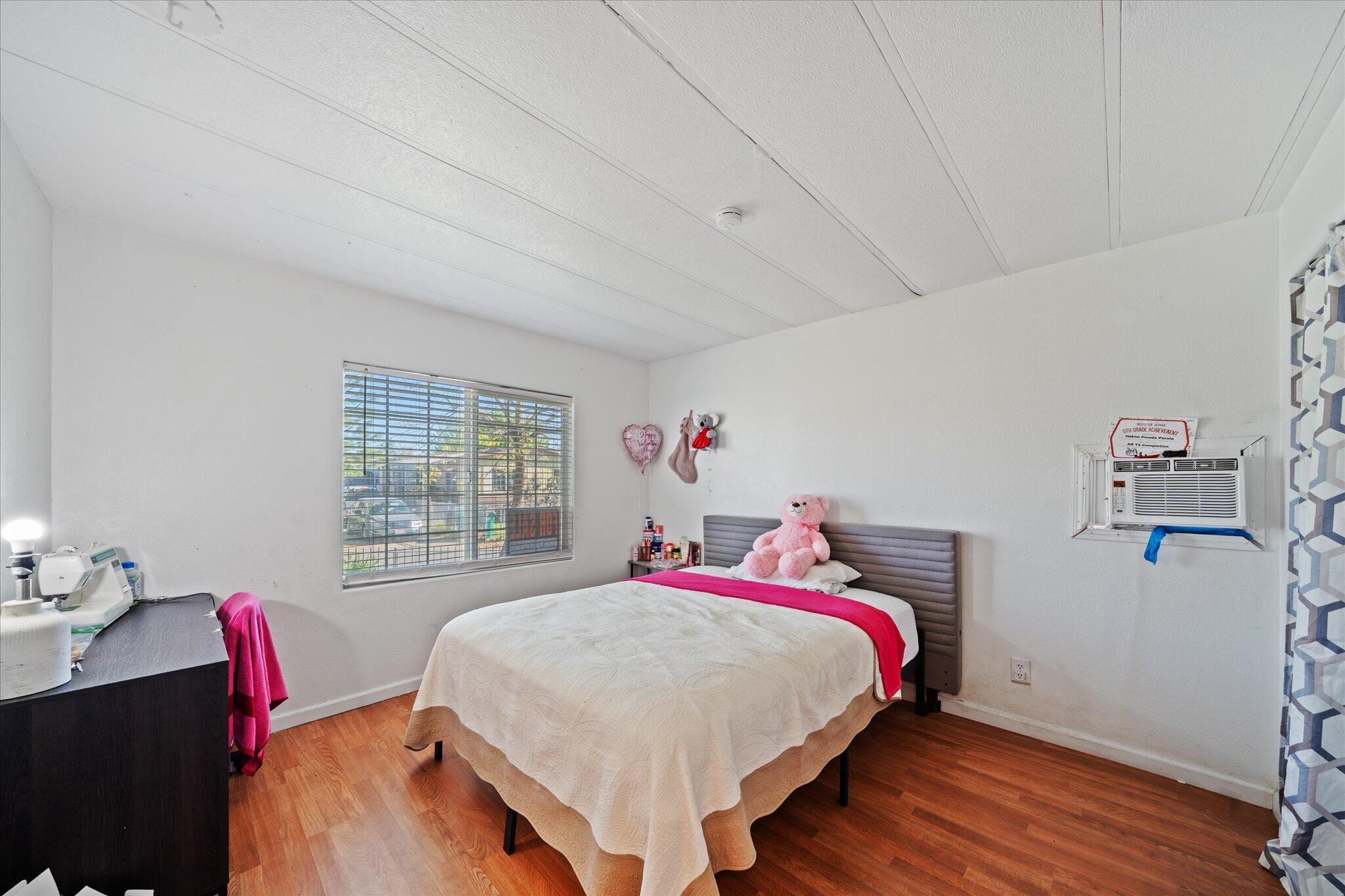 2494 Delta Place, Unit 71 Redding, CA 96002 - Photo 18 of 24 a bed room with a bed and a desk