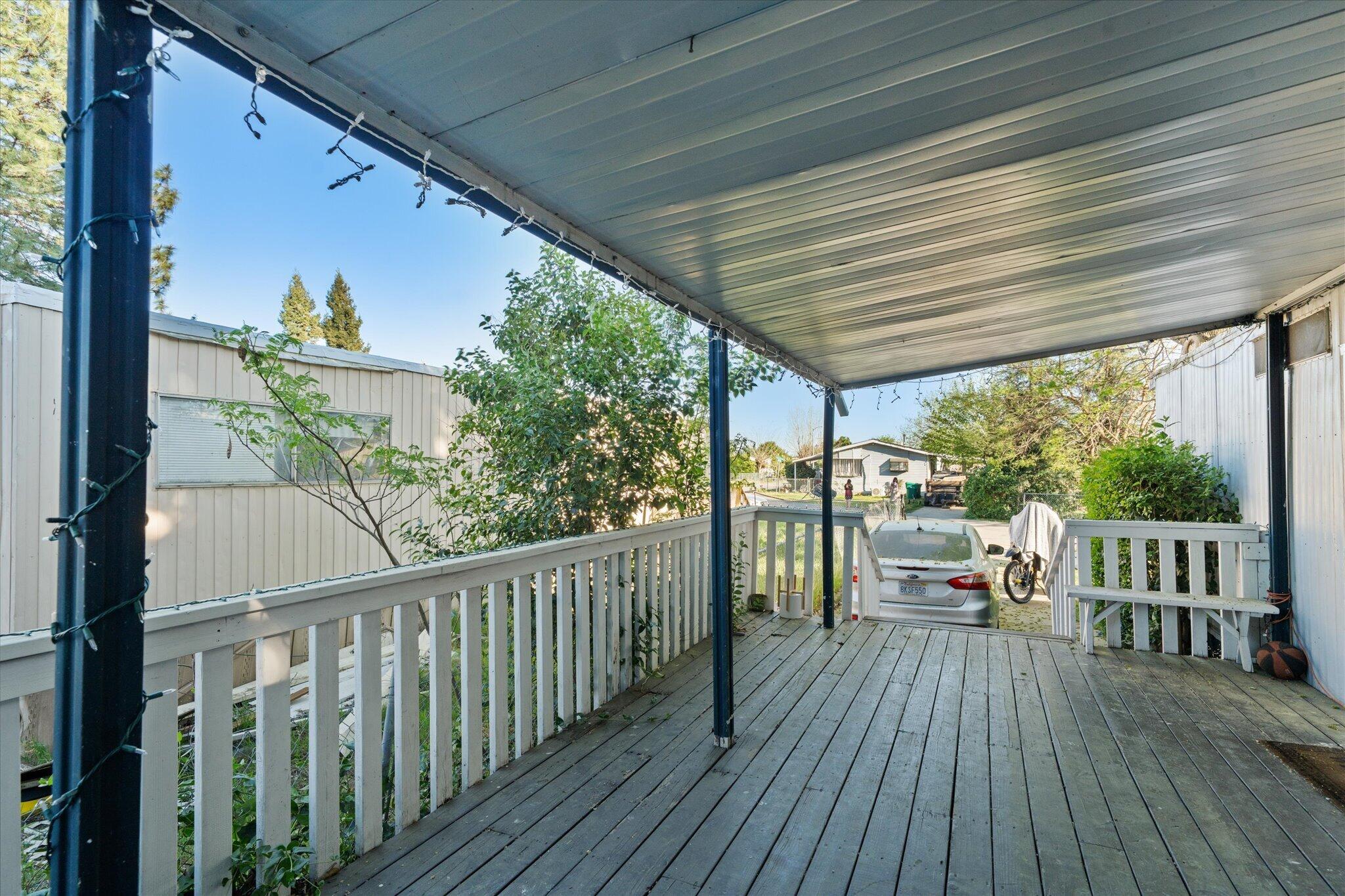 2494 Delta Place, Unit 71 Redding, CA 96002 - Photo 2 of 24 a view of a chairs and table on the wooden deck