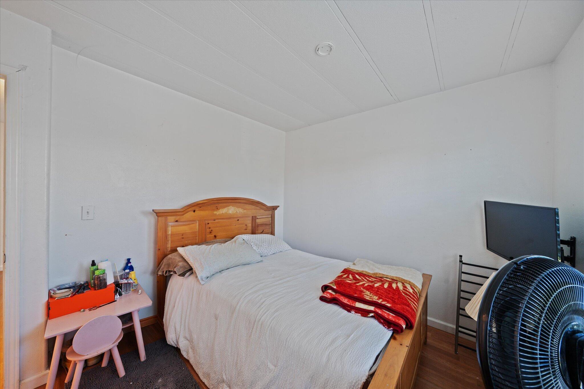 2494 Delta Place, Unit 71 Redding, CA 96002 - Photo 21 of 24 a bedroom with a bed and wooden floor