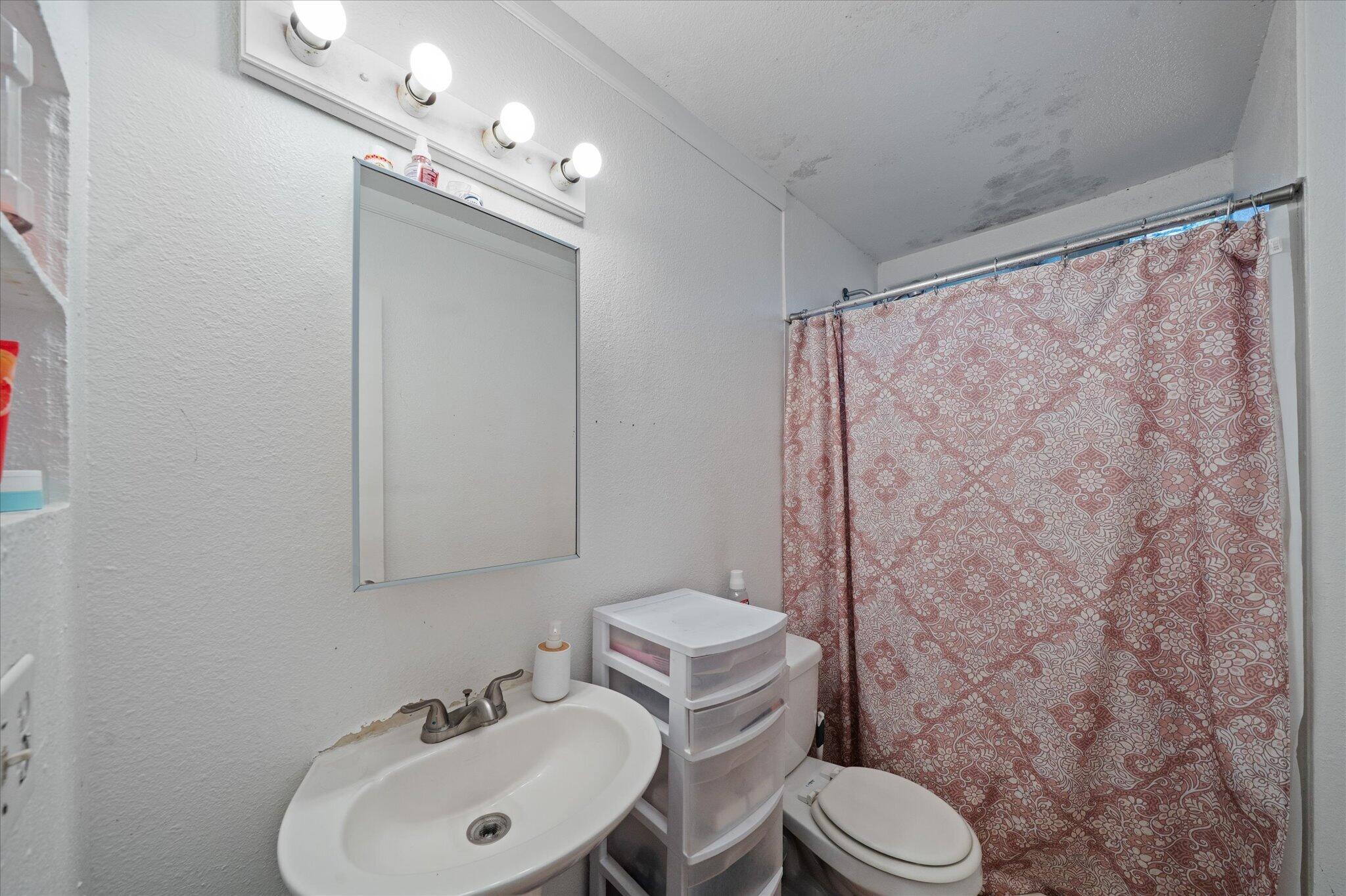 2494 Delta Place, Unit 71 Redding, CA 96002 - Photo 22 of 24 a bathroom with a toilet sink and mirror