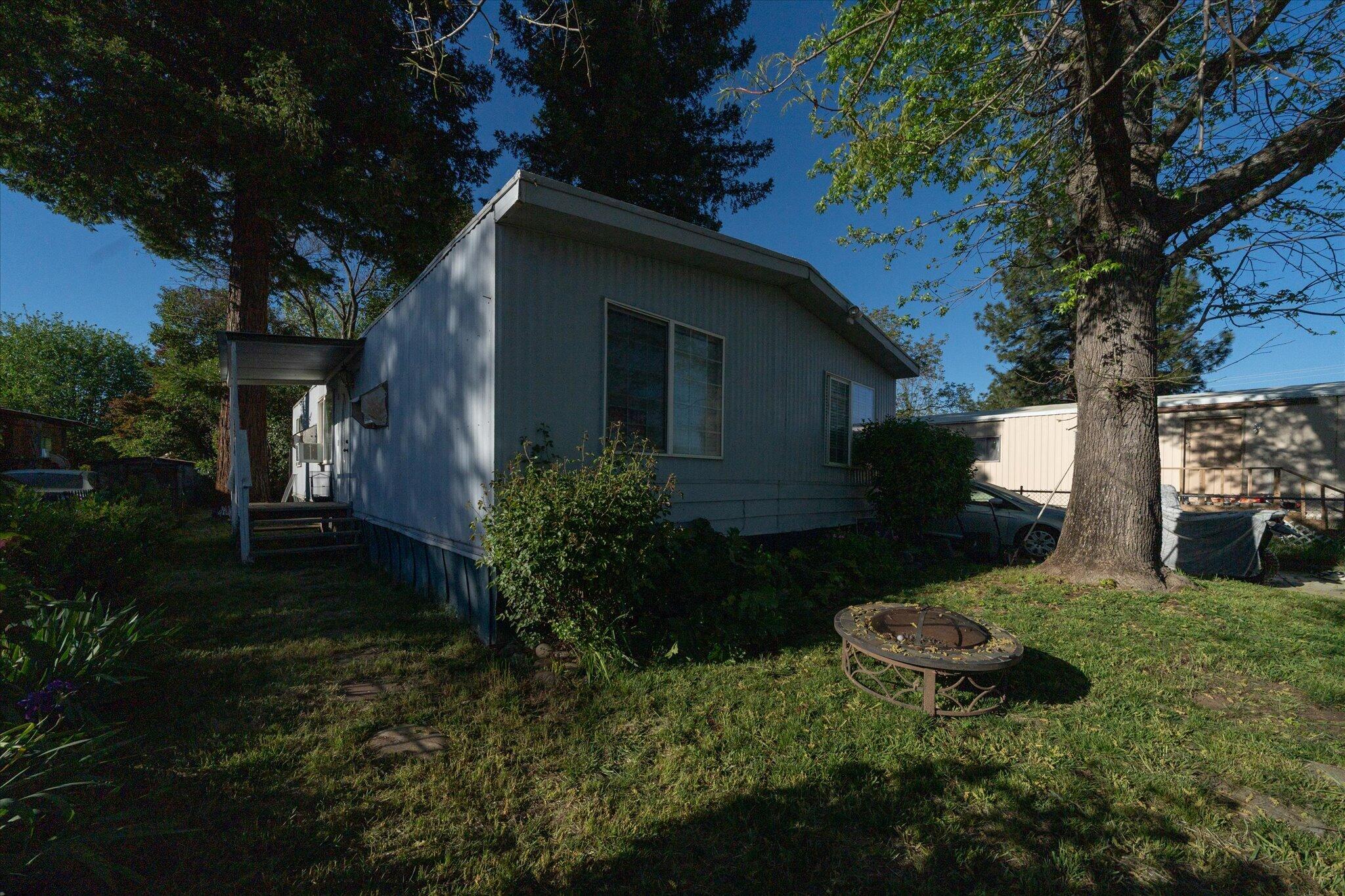 2494 Delta Place, Unit 71 Redding, CA 96002 - Photo 23 of 24 a view of a house with a yard