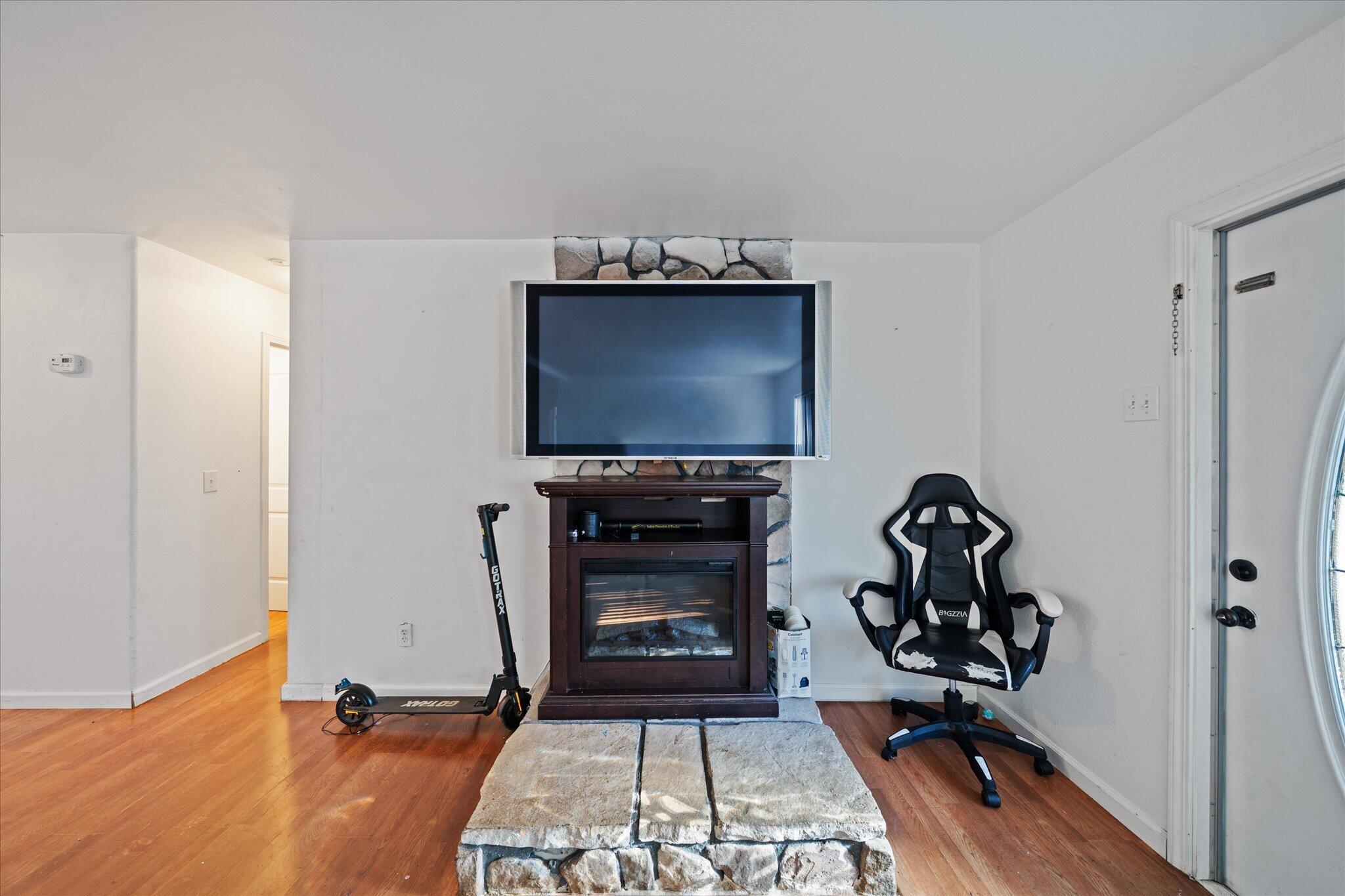 2494 Delta Place, Unit 71 Redding, CA 96002 - Photo 5 of 24 a living room with furniture a flat screen tv and a fireplace